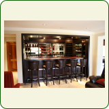 Home bar. Customised veneer bar with solid tops and stainless steel strip